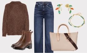 Ein stilvolles Outfit-Arrangement bestehend aus einem braunen, grob gestrickten Pullover, einer klassischen Jeans, braunen Stiefeletten und einer eleganten, beigen Handtasche. Dazu passen farbenfrohe Ohrringe und ein Armband, die dem Look einen modischen 